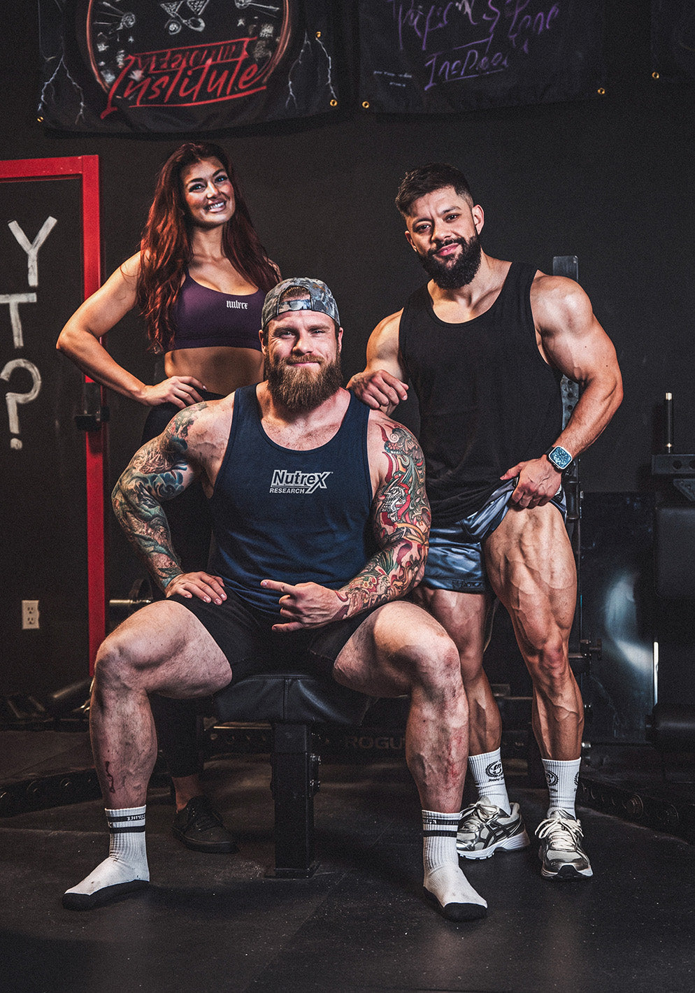 Group of Nutrex athletes wearing brand tank tops in gym